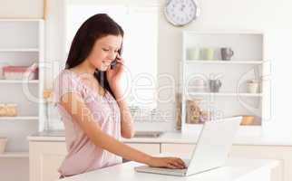 Woman telephoning and typing