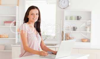 Woman with credit card and laptop looking