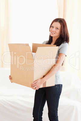 Woman holding filled cardboard