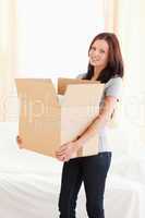 Woman holding filled cardboard