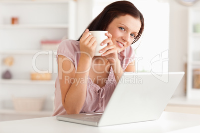 Woman with cup of coffe and notebook