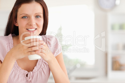 Woman with cup of coffe looking