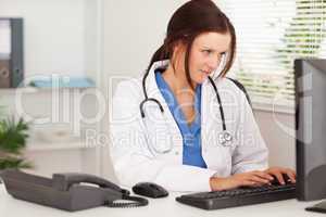 Female doctor typing on keyboard
