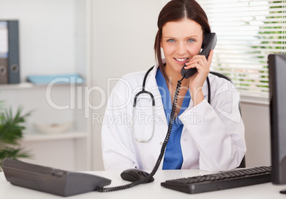 Female doctor telephoning