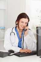 Female doctor telephoning and looking