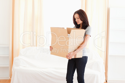 A woman carrying a cardboard