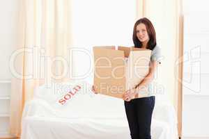 Woman holding full cardboard