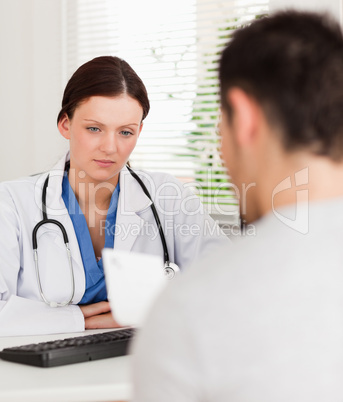 Female doctor and a patient reading prescription
