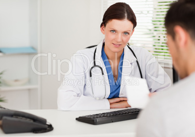 Female doctor with patient and prescription
