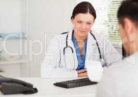 Doctor in office with patient reading prescription