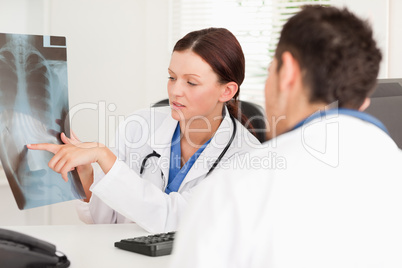 Female doctor showing other doctor a x-ray