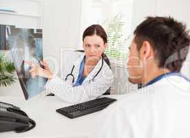 Female doctor showing other doctor x-ray