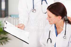 Doctor showing female doctor file