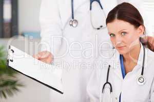 Doctor showing female doctor a file