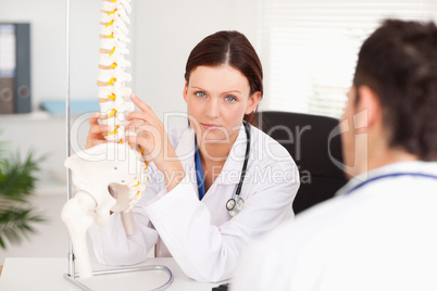 Female doctor touching spine
