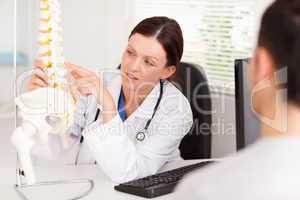 Female doctor pointing on a bone