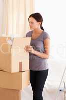 Woman packing a cardboard