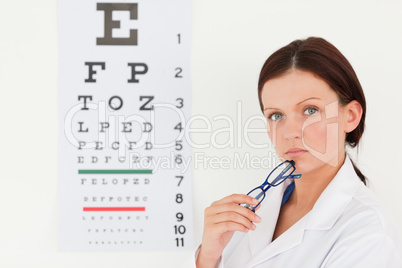 Pretty female optician and eye test
