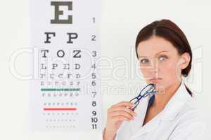 Pretty female optician and eye test