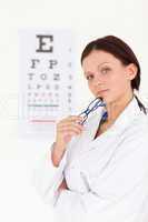 A female optician with an eye test