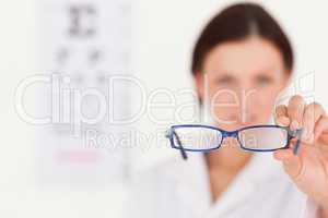 Blurred optician showing glasses