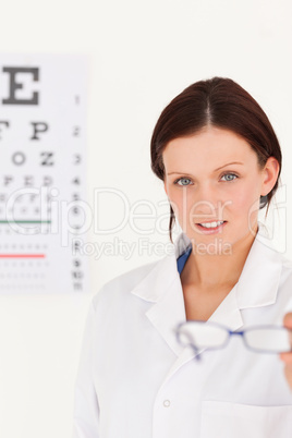 Female optician showing glasses