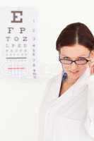 Female optician with glasses in office
