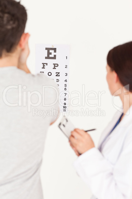 Female optician and patient in office