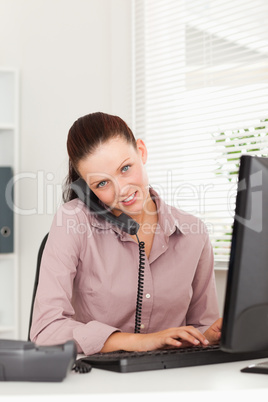 Businesswoman with phone typing