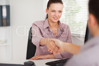 Businesswoman shaking hands with customer