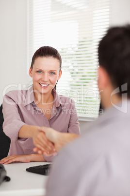 Businesswoman shakes hands with a man