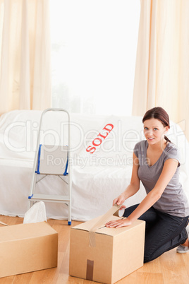 Woman preparing cardboards for transport