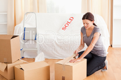 Female preparing cardboards for transport