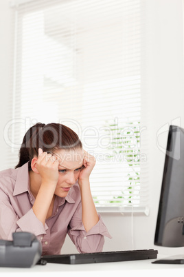 A frustrated businesswoman in her office