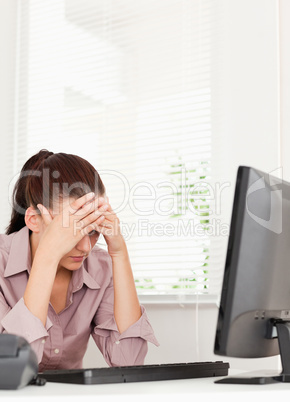 A frustrated businesswoman sitting in her office