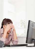 A frustrated businesswoman sitting in her office