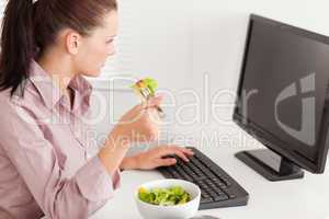 Businesswoman eating salad