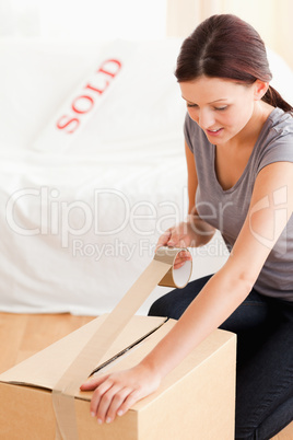 Woman preparing a cardboard for transport