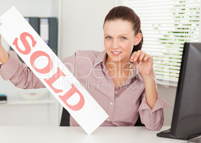 Businesswoman shows sold sign