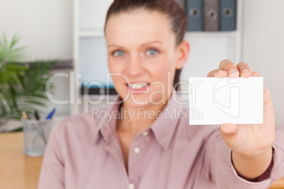 Beautiful businesswoman holding a card