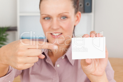 Business woman pointing at a card