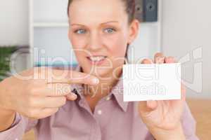 Business woman pointing at a card
