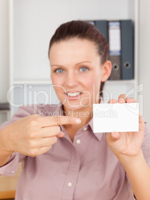 Red-haired business woman pointing at a card