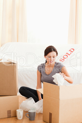 Cute woman packing her things