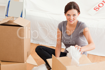 Young woman clearing out looking into the camera