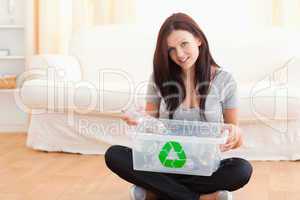 Cute woman with a recycling box