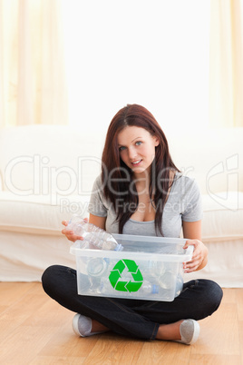 Gorgeous woman with a recycling box