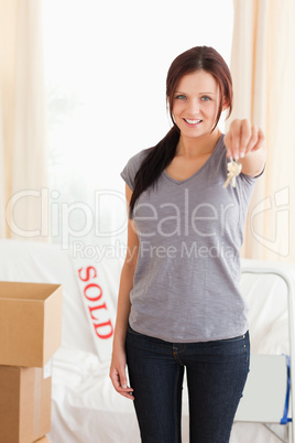 Portrait of a redheaded lady holding keys