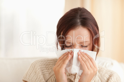 Sneezing cute woman