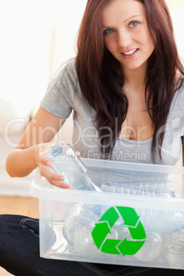 Woman recycling plastic bottles